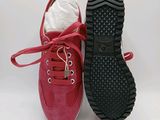 two pairs of red shoes with black soles on a white background