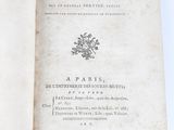 an open book with a black and white image of a flower