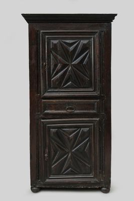 an old wooden cabinet with two doors and a clock on top of it
