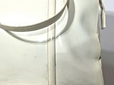 a white purse sitting on top of a white table