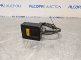 a picture of a black and yellow electronic device on a table