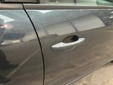 a silver car with a hole in the side door