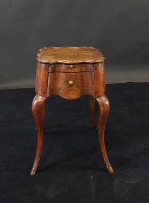 a small wooden table with a drawer on top of it