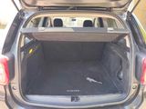 the back of a car with its trunk open and the back seats folded down