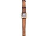 a close up of a watch on a white background with a brown strap