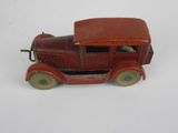a red toy truck that is sitting on a white surface