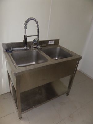 two sinks in the kitchen with a faucet on the side