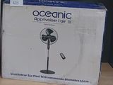 a box with a fan on the table next to a box with a remote