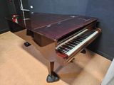 a piano that is sitting on the floor in the room