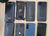 a lot of different cell phones that are on the table
