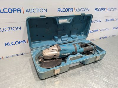 an electric drill in a blue case on a table next to a box