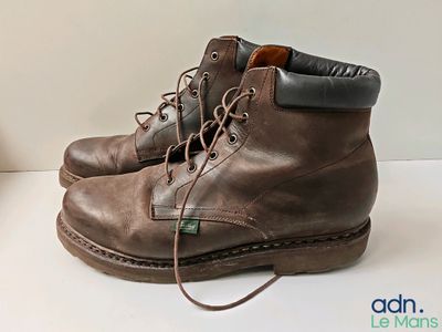 a pair of brown boots that are on a table