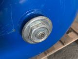 a blue ball with a nut on it sitting on a pallet