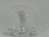 clear glass figurine of a man with a hat on his head