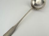 a silver spoon with a spoon handle on a white surface