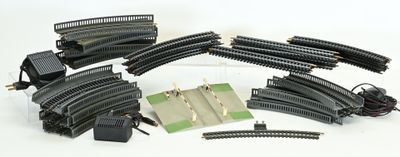 a lot of black train tracks and wires on a white surface