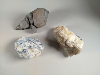three rocks that are sitting on a table