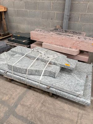 a pile of grey granite blocks on a pallet