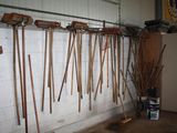 a lot of tools hanging on the wall in the garage