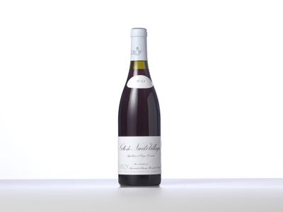 a bottle of wine sitting on top of a white table