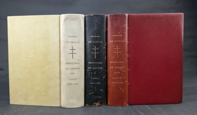 three old books sitting on top of each other on a table