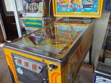 a pinball machine sitting on a table in a room