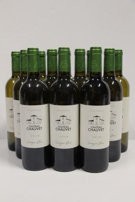 six bottles of wine are lined up in a row on a white surface