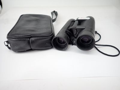 a black bag and a pair of binoculars on a white table