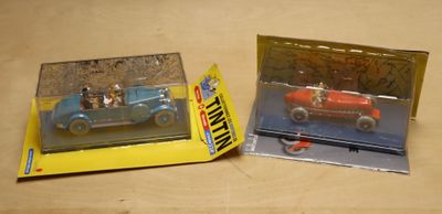 two toy cars that are in a box on a table