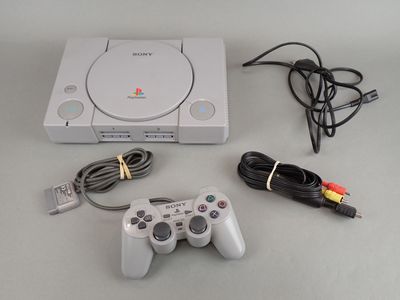 a video game console with a game controller next to it