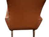 brown leather chair with riveted back and legs