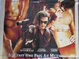 une affiche de cinéma représentant un homme tenant une arme à feu devant une femme
