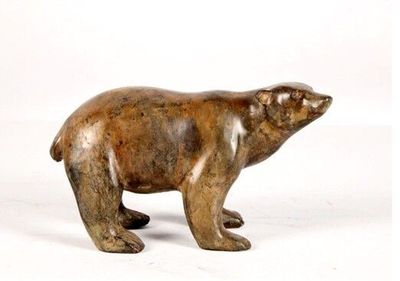 a small statue of a polar bear on a white background