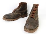 pair of brown boots with brown laces on them on a white surface