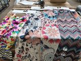 many different types of fabrics on a table
