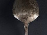 a spoon that is sitting on a black surface