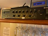 a rack with wine glasses and a radio on it