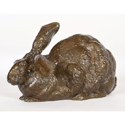bronze sculpture of a rabbit on a white background