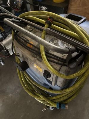 a pile of hoses sitting on top of a machine in a garage