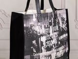 black and white photo of a shopping bag on a wooden table