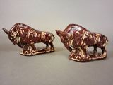 pair of ceramic bull figurines with brown and white designs