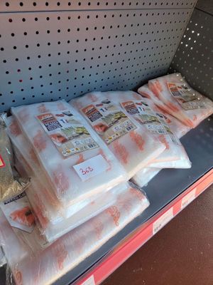 many bags of food sitting on a shelf in a store