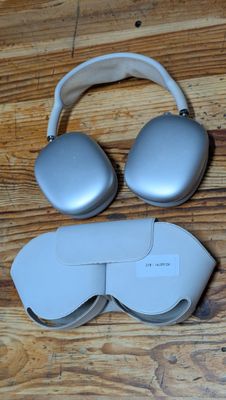 a pair of headphones and a pair of glasses on a wooden floor