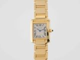 a close up of a gold wrist watch with roman numerals
