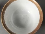 two white and brown bowls sitting next to each other on a table
