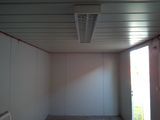 a room with a ceiling fan and a window in it