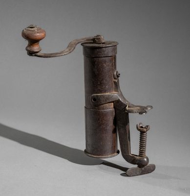 an image of an old coffee grinder on a gray background