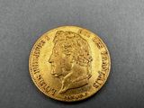 a close up of a gold coin with a man ' s face on it