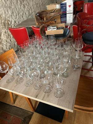 many wine glasses sitting on a table in a room