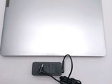 a laptop with a charger attached to it on a table